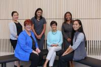 Group of six women posing for the camera.